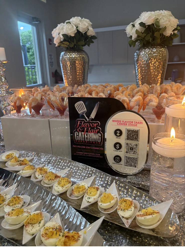Flavor and Flair Catering Gourmet Bites appetizer display with deviled eggs, shrimp cocktail, and handcrafted bites